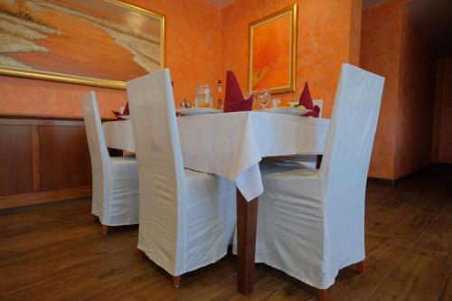 a dining room with a white table and chairs at Motel Mujanic Sarajevo in Sarajevo