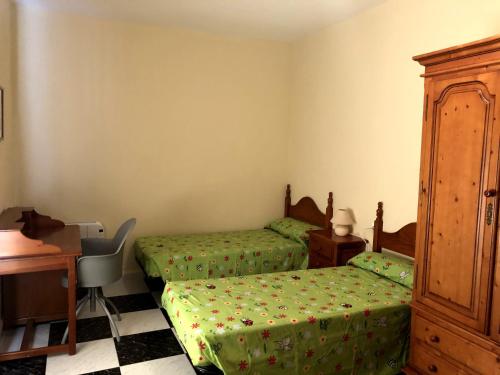 a bedroom with two twin beds and a desk at Alojamiento Rural VillaSol in La Piedra de la Sal