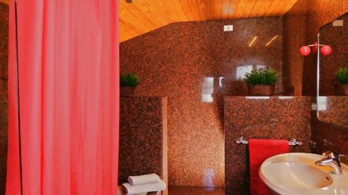 a bathroom with a sink and a toilet and a shower at Chalet "Rec dels Noguers" in Castellciutat
