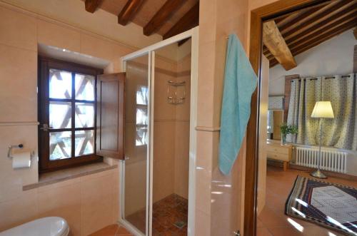 bagno con doccia, finestra e servizi igienici di I Cipressi a Castelnuovo Berardenga