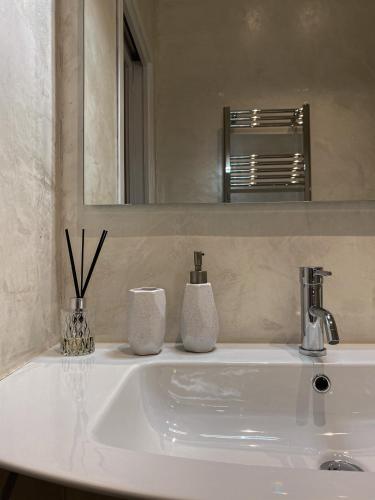 a bathroom sink with two vases on top of it at Casa Mar - B&B - in Terracina