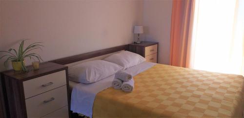 a bedroom with a bed with a stuffed animal on it at Relax in Črni Kal in Črni Kal