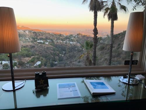 a desk with two lamps and a window with a view at HOLLYWOOD HILLS JETLINER VIEWS at STUDIO 1080 HOLLYWOOD in Los Angeles