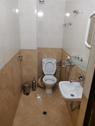 a bathroom with a toilet and a sink at Къща за гости Кадиеви in Primorsko