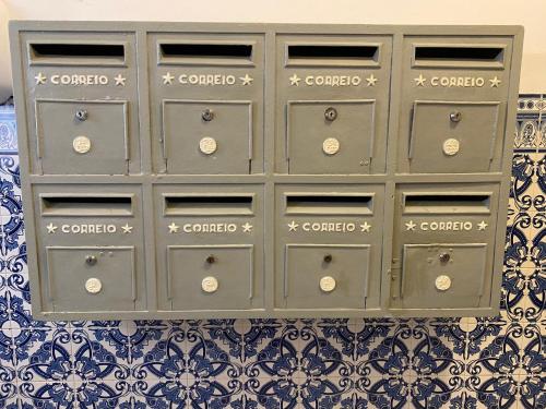 a gray cabinet with drawers on a wall at Mouraria 1 - Descubra a Lisboa Medieval in Lisbon