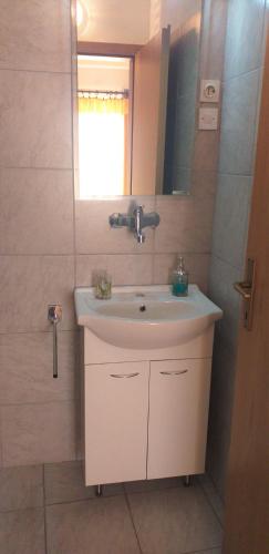 a bathroom with a sink and a mirror at Relax in Črni Kal in Črni Kal