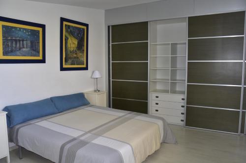 sypialnia z łóżkiem i półkami w obiekcie La Casa del Pas w mieście Sant Jaume d'Enveja