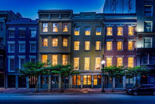 a large building with lit windows on a city street at The Alexandre in New Orleans