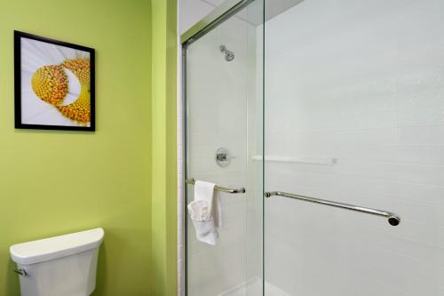 a bathroom with a shower and a toilet with a glass door at La Quinta Inn & Suites by Wyndham Braselton in Braselton