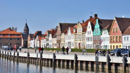 a group of buildings next to a body of water at Stilbruch Glückstadt in Glückstadt