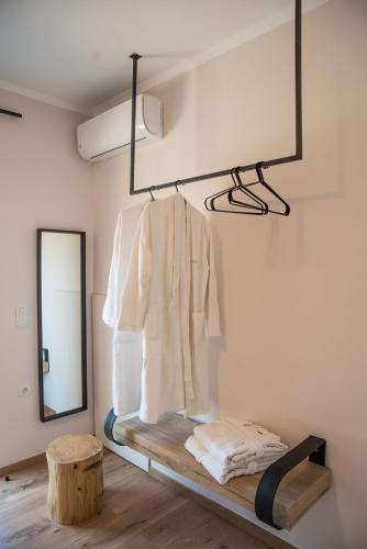 a room with a mirror and a shelf with a white shirt at Horizon Villa Almyrida in Almyrida