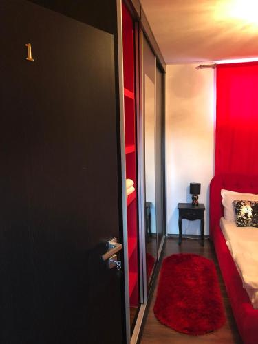 a room with a red bed and a red door at Casa B&D Residence in Deva