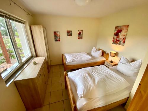 um pequeno quarto com 2 camas e uma janela em Ferienhaus Gutedel em Freyburg