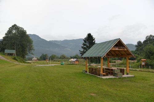 a gazebo in a field with mountains in the background at Tara Place - Camp Rabrenovic in Mojkovac