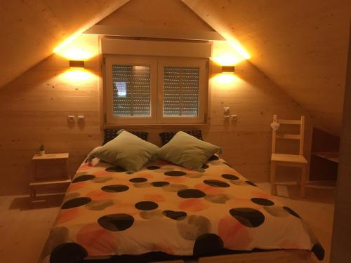 a bedroom with a bed in a attic at Le Chalet in Aywaille