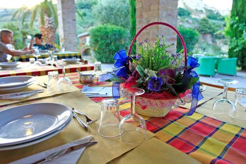 a table with a basket of flowers on top of it at La Panoramica Country House in San Benedetto del Tronto