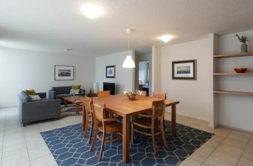a dining room and living room with a table and chairs at Apartamentos West End in Guadalajara