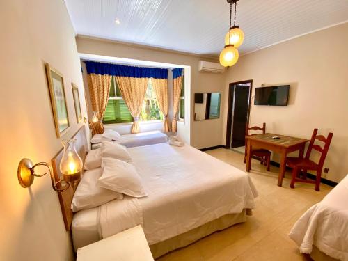 Postel nebo postele na pokoji v ubytování Hotel Vila Bavária