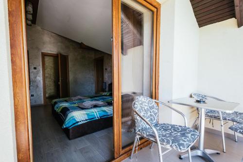a mirror in a room with a bed and a table at ATOS Srebrno jezero - Villa and Restaurant in Veliko Gradište