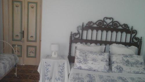 a bedroom with a bed and a table with a lamp at Villa Di Miscio in SantʼAgata di Puglia