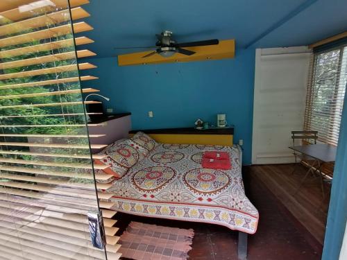a bedroom with a bed with a blanket on it at Casa Rural Aroma de Campo in Curubandé