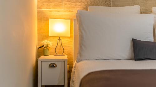 a bedroom with a bed and a lamp on a night stand at The Georgetown House Inn in Washington