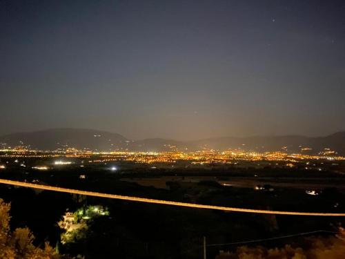 a night view of a city with a highway at Agriturismo Casa Orsini in Montefalco