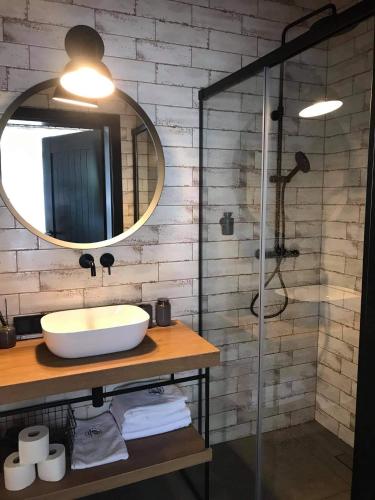 a bathroom with a sink and a mirror at Bieszczadzka Stodoła in Ustrzyki Dolne