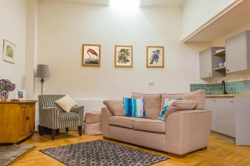 a living room with a couch and a chair at The Old Sunday School in Helston