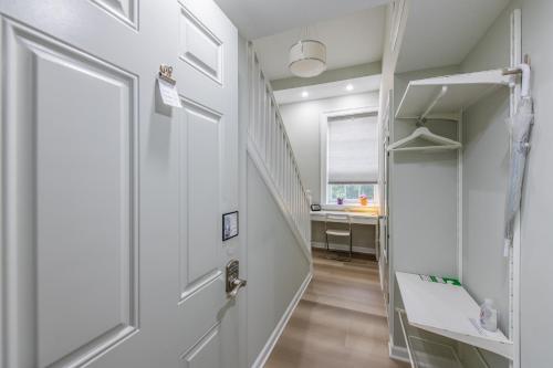 a hallway with a white door and a desk at The Georgetown House Inn in Washington