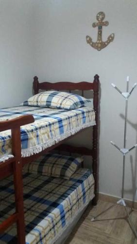 a bedroom with a bunk bed with a anchor on the wall at Village dos Pássaros Apartamento in Guarapari