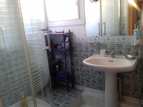 a bathroom with a sink and a shower at Les Trois Rois in Nîmes
