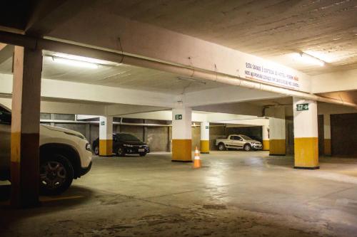 a parking garage with cars parked in it at Riviera Palace Hotel in Sete Lagoas