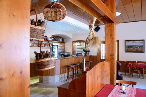 a restaurant with a bar with wooden walls at Hotel Leopold Račín in Račín