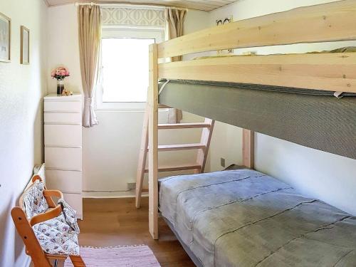 a bedroom with a bunk bed and a ladder to a bunk bed at Holiday home Nordborg XIII in Nordborg