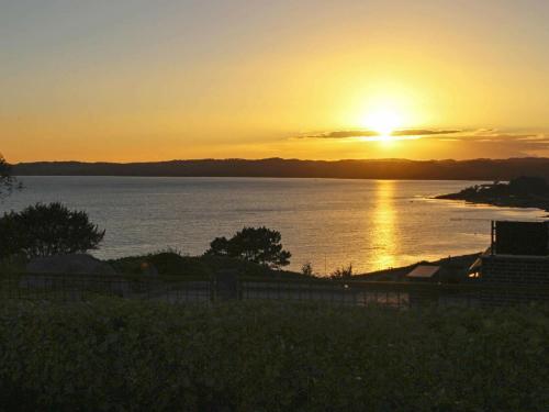 a sunset over a large body of water at 6 person holiday home in Ebeltoft in Fårvang