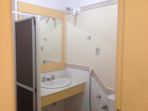 a bathroom with a sink and a mirror at Nascimento Praia Hotel in Aracaju