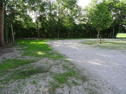 an empty road with trees and grass in a park at Airport Park Hotel MUC in Hallbergmoos