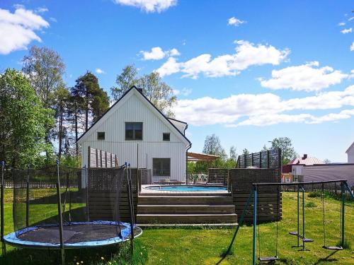 a backyard with a house and a pool at 8 person holiday home in BILLINGSFORS in Billingsfors