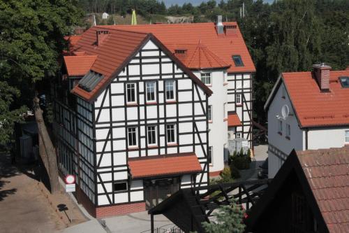 an aerial view of a white and black building with red roofs at Fisherman's House in Ustka