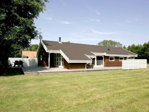 a house with a large yard in front of it at 8 person holiday home in Aakirkeby in Vester Sømarken