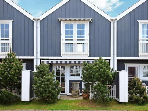 a large blue house with white trim at 4 person holiday home in Blåvand-By Traum in Blåvand