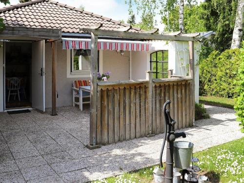 a house with a fence and a bike in the yard at 3 person holiday home in H LLVIKEN in Höllviken