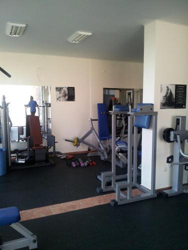a gym with several machines and a man in the background at Sandanski Peak Guest Rooms in Sandanski