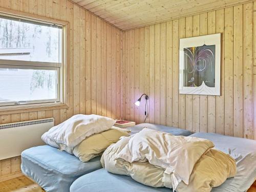 A bed or beds in a room at Three-Bedroom Holiday home in Aakirkeby 5