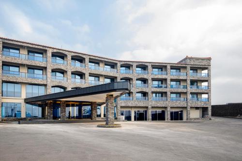 a large office building with a black roof at Aewol Stay in Jeju Hotel&Resort in Jeju