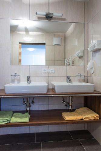 a bathroom with two sinks and a mirror at Appartements Plaija in Sankt Anton am Arlberg