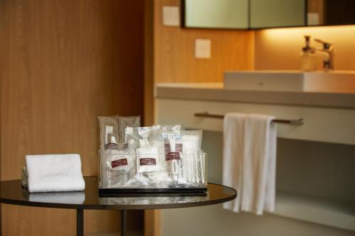 a table in a hotel room with toiletries on it at MGH Mitsui Garden Hotel Taipei Zhongxiao in Taipei