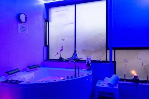 a large bathroom with a large tub with a window at Hotel & Spa Real Ciudad De Zaragoza in Zaragoza