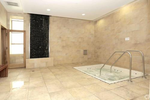 a large bathroom with a bath tub in a room at Perfect Apt near UCLA w Parking Gym Pool WIFI in Westwood B3 in Los Angeles
